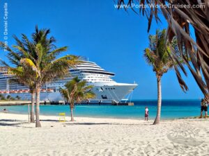 Praia paradisíaca no Caribe com areia branca, mar azul-turquesa, coqueiros e um navio de cruzeiro MSC ao fundo