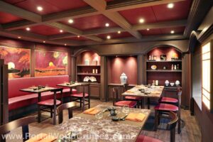 Salão principal do restaurante de especialidade Kaito Sushi Bar, com mesas e decoração em tons de vermelho